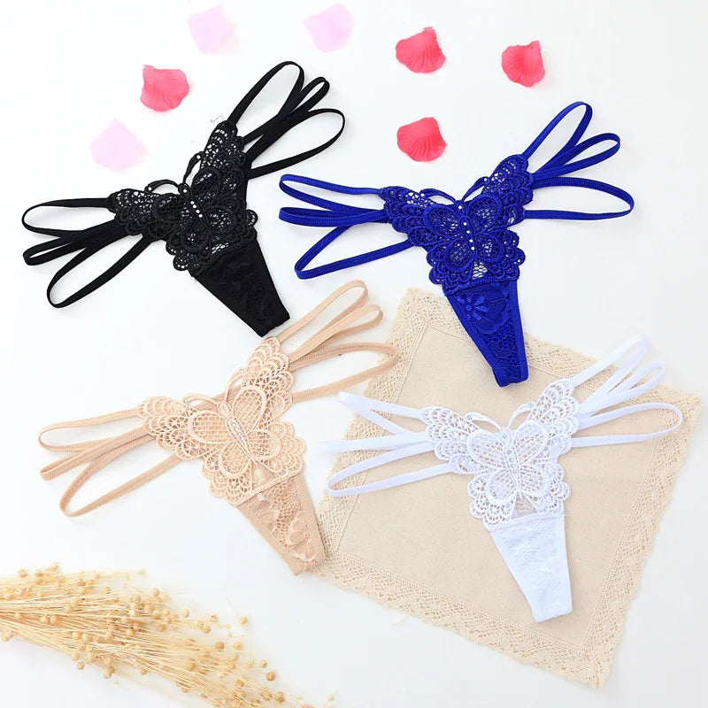 Four lace butterfly thong panties in black, blue, beige, and white with strappy sides, flat lay display.