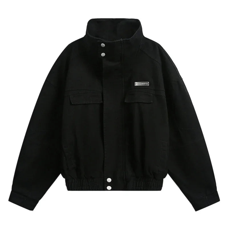 Black oversized streetwear jacket with high collar, snap buttons, and front flap pockets
