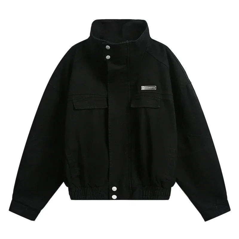 Black oversized streetwear jacket with high collar, snap buttons, and front flap pockets