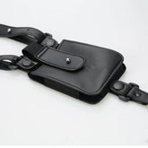 Black faux leather streetwear utility pouch with adjustable straps and metal snap closures