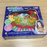 Animal farm piano toy in colorful box with cartoon animal characters and music keys, on wood surface.