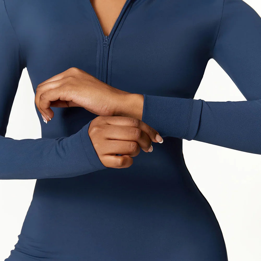 Fitted long sleeve navy blue top with front zipper, smooth stretch fabric, modern streetwear style.