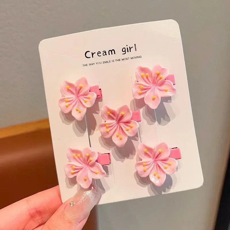 Set of five pink cherry blossom flower hair clips with yellow accents, feminine hair accessory