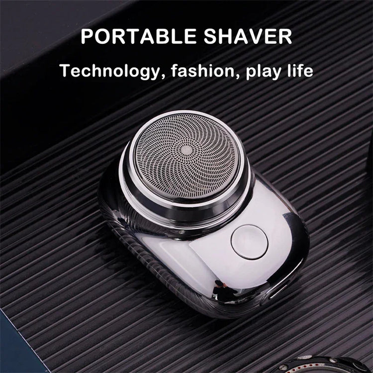 Sleek silver portable electric shaver with circular foil head on ribbed black surface