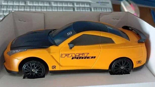 Yellow and black toy sports car with 'Fast Power' text, packaged in a white box.
