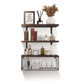 Wall-mounted dark wood shelves with decor, books, glassware, and storage bottles.