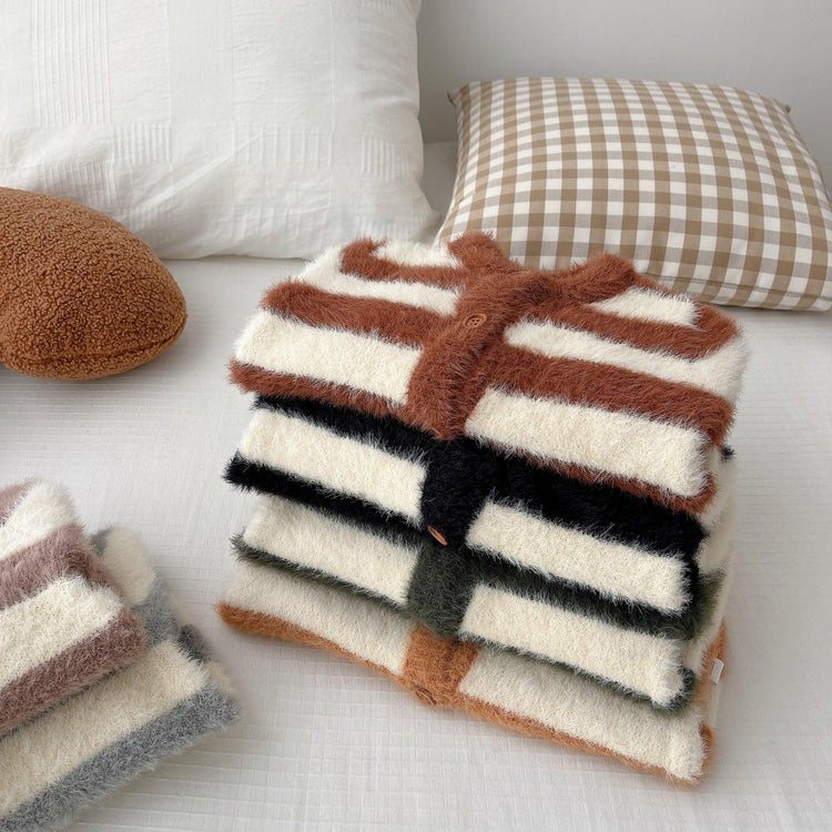 Stack of fuzzy striped cardigans in brown, black, and green tones, soft knit, relaxed fit
