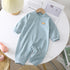 Light blue striped baby romper with snap buttons and long sleeves, soft cotton material, relaxed fit