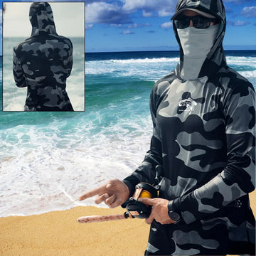 Man wearing black and grey camo hooded long sleeve sun shirt, relaxed fit, fishing on beach