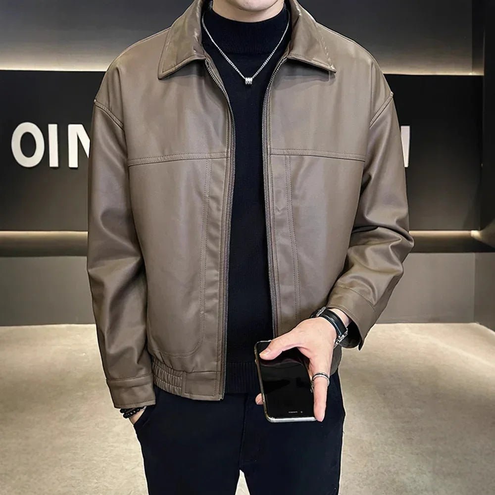 Man wearing a brown faux leather jacket with relaxed fit and zip front over black turtleneck