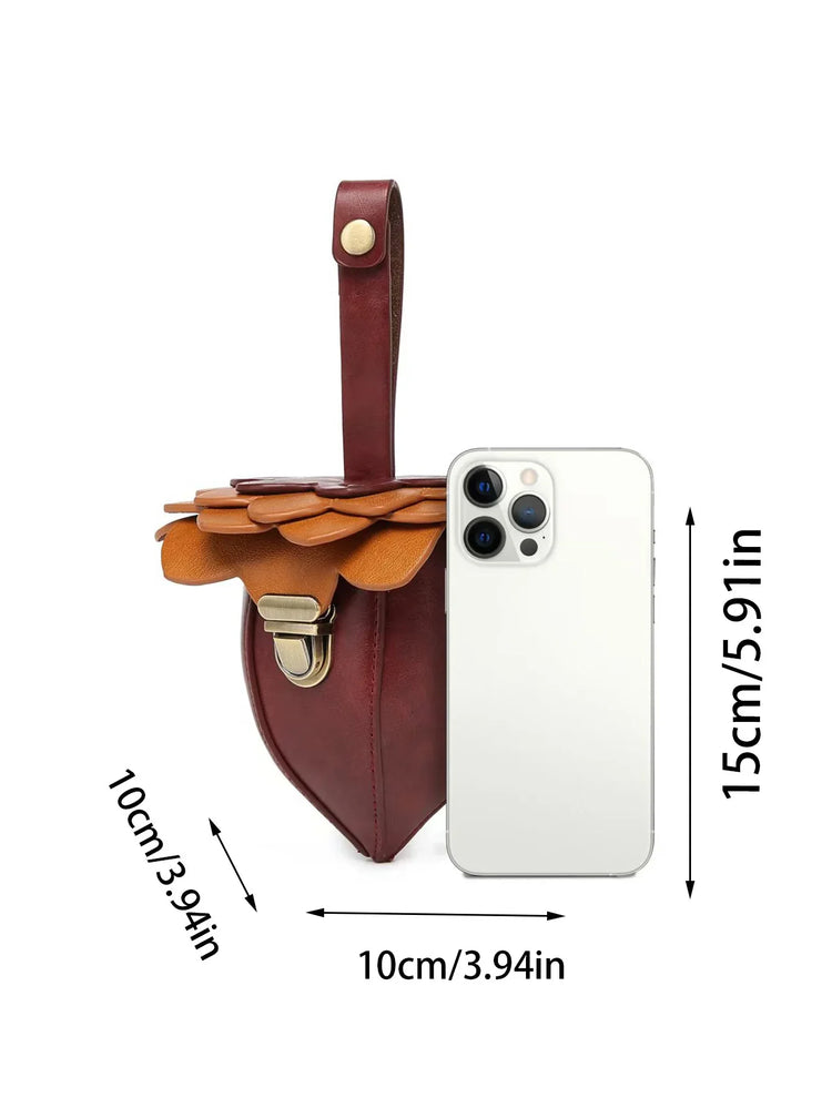 Brown and tan leather mini crossbody bag with layered flap, gold clasp, compact size shown next to smartphone.