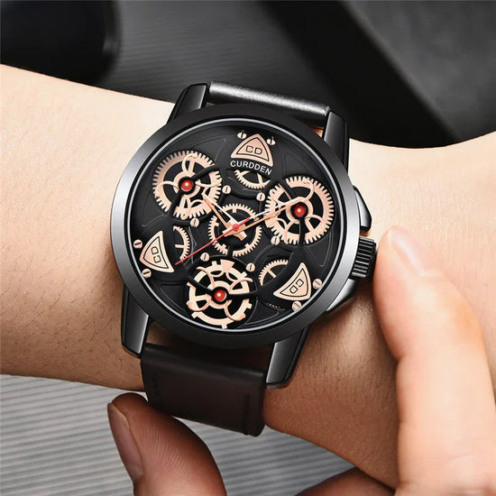 Black leather strap watch with exposed gold gears and modern skeleton dial design