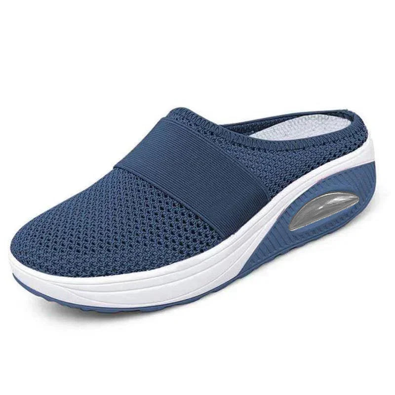 Navy blue slip-on mesh sneaker with elastic band, breathable upper, and thick white sole