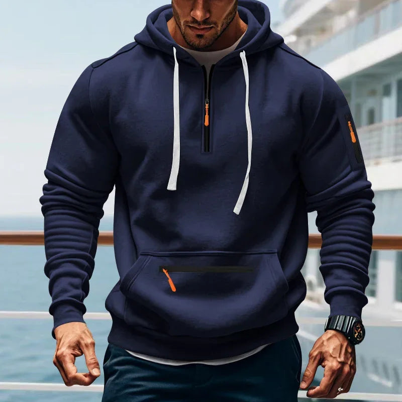 Man wearing a navy blue athletic hoodie with white drawstrings, front pocket, slim fit