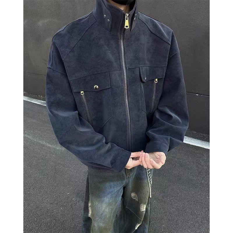 Man in an oversized black suede zip-up jacket with flap pockets and distressed jeans