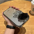 Silver glitter robot-themed phone case with metallic accents, held in hand