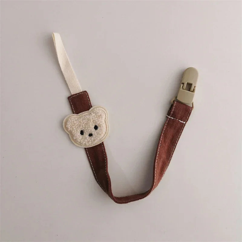 Brown fabric clip strap with beige bear face applique and plastic clasp, cute accessory