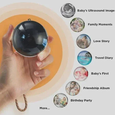 Hand holding a reflective black sphere accessory with chain, modern minimalist design.