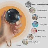 Hand holding a reflective black sphere accessory with chain, modern minimalist design.