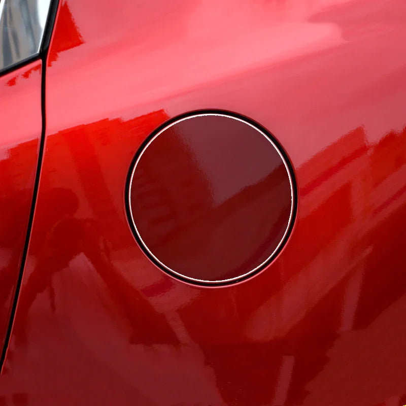 Close-up of red metallic car fuel tank door with glossy finish