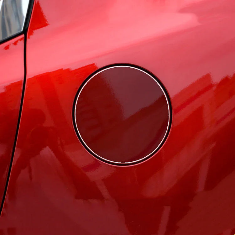 Close-up of red metallic car fuel tank door with glossy finish