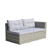 Modern gray rattan outdoor sofa with light gray cushioned seating and backrest
