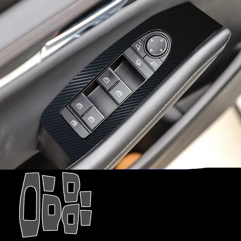 Black carbon fiber car window switch panel cover with glossy finish, fitted on driver side door.