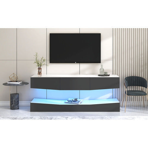Grey particleboard hanging TV stand with LED lighting mounted on wall beneath a flat-screen TV in modern living room setting