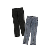 Black and gray straight-leg jeans with full-length side zippers and raw hem details