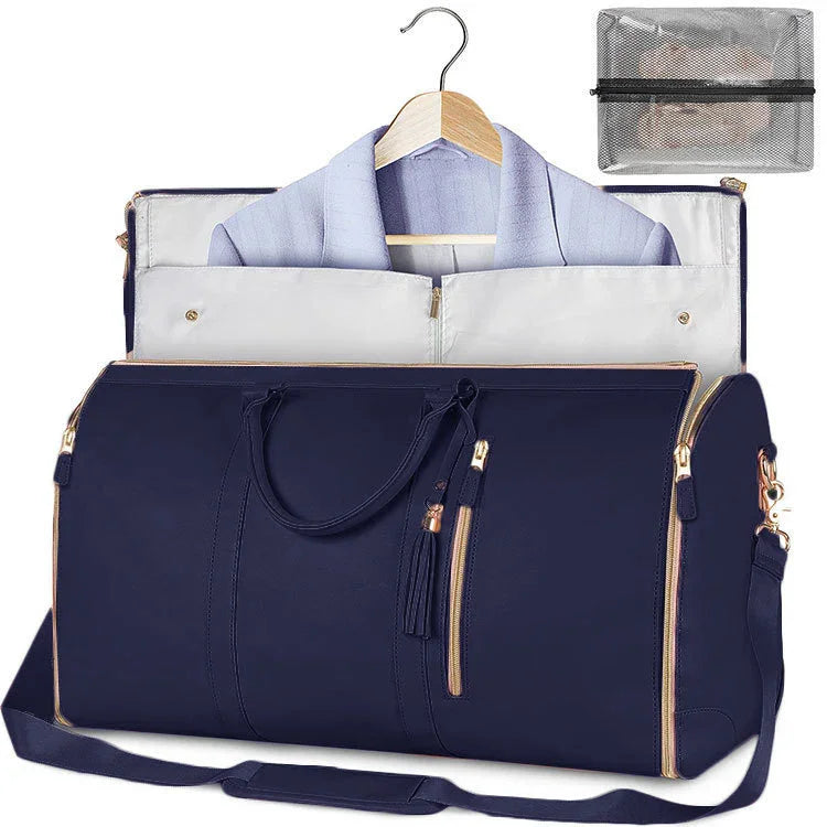 Navy blue garment bag with gold zippers, soft shoulder strap, and suit inside