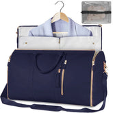 Navy blue garment bag with gold zippers, soft shoulder strap, and suit inside