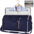 Navy blue garment bag with gold zippers, soft shoulder strap, and suit inside