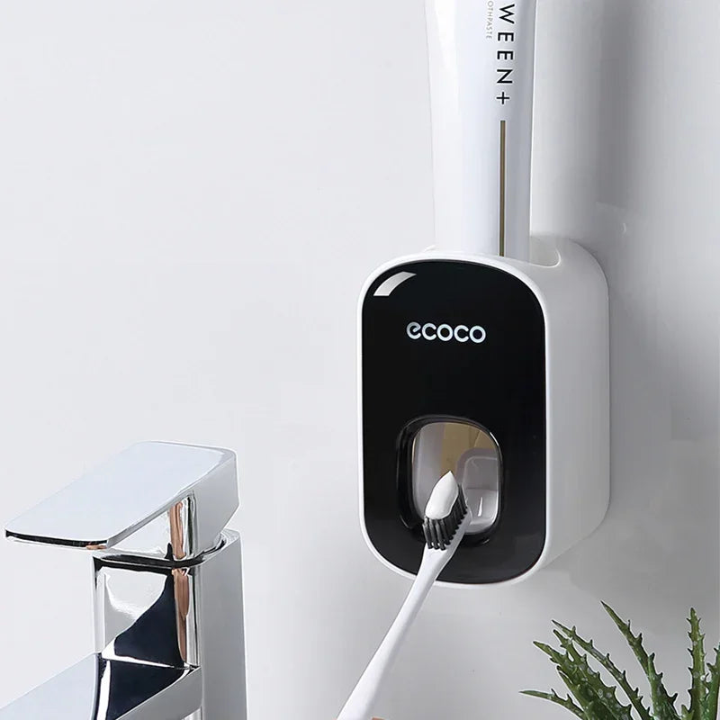 Wall-mounted automatic toothpaste dispenser in black and white plastic, modern bathroom setting