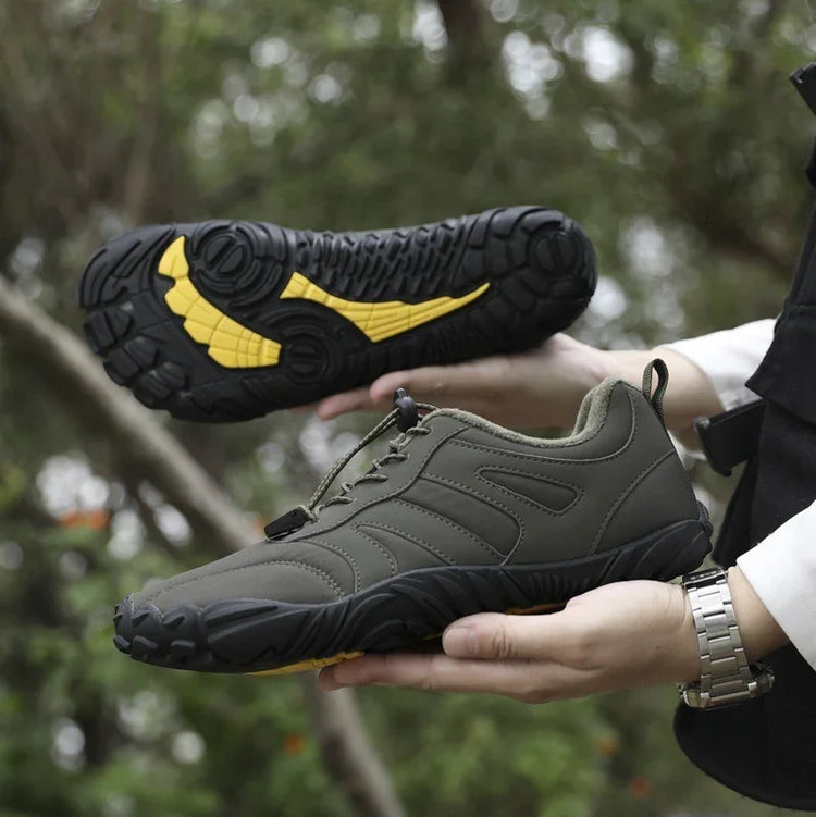 Olive green athletic sneakers with black and yellow rubber soles, outdoor setting, casual fit