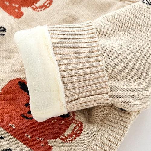 Beige knit sweater sleeve with ribbed cuff, fleece lining, and playful red crab print