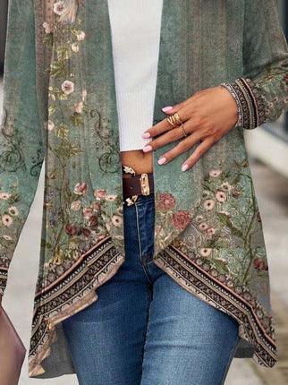 Green floral patterned cardigan with long sleeves, relaxed fit, worn over white top and jeans.