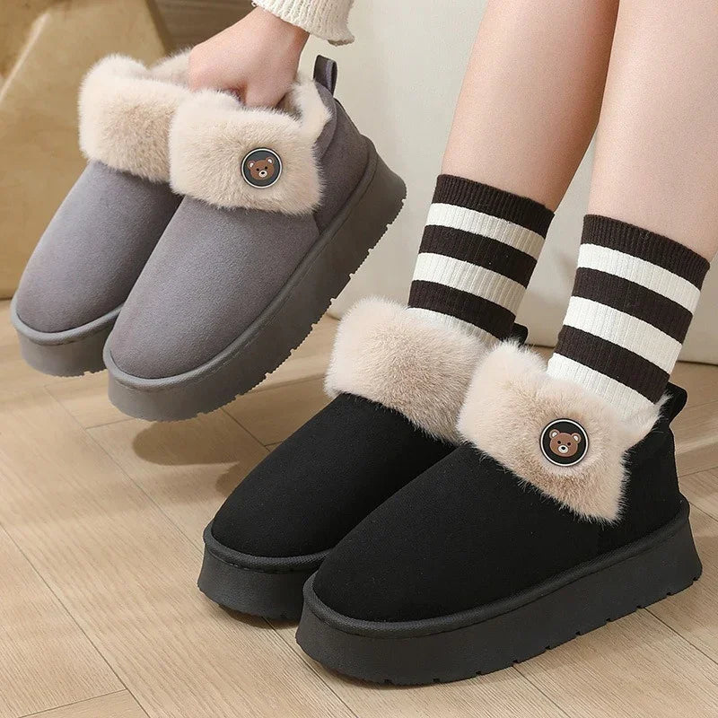 Cozy slip-on winter shoes in black and grey with faux fur lining and bear button detail