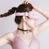 Woman in pink satin camisole with slim fit wearing a soft pink tech eye mask