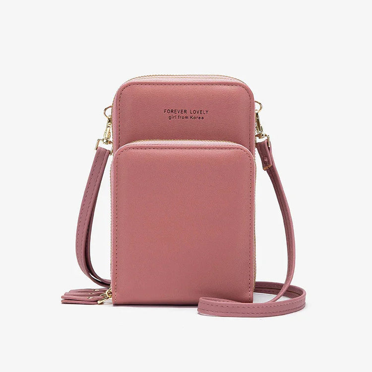 Pink faux leather crossbody bag with front pocket and gold zipper detailing