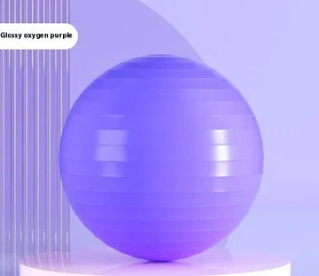 Glossy purple exercise yoga ball on a modern minimalistic display stand.