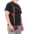 Man wearing a brown leather camera harness with adjustable straps, casual black t-shirt