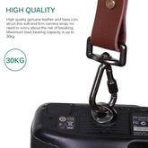 Brown genuine leather camera strap with metal clasp, attached to camera, durable and adjustable.