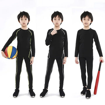 Kids wearing black athletic long-sleeve shirt and leggings with colored side stripes, slim fit.