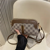 Brown and beige crossbody bag with monogram canvas, faux leather trim, and gold hardware.