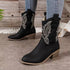 Black mid-calf cowboy boots with embroidered design, chunky heel, styled with skinny jeans
