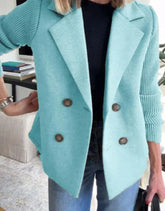 Woman wearing a light blue double-breasted wool blazer with ribbed sleeves and casual fit