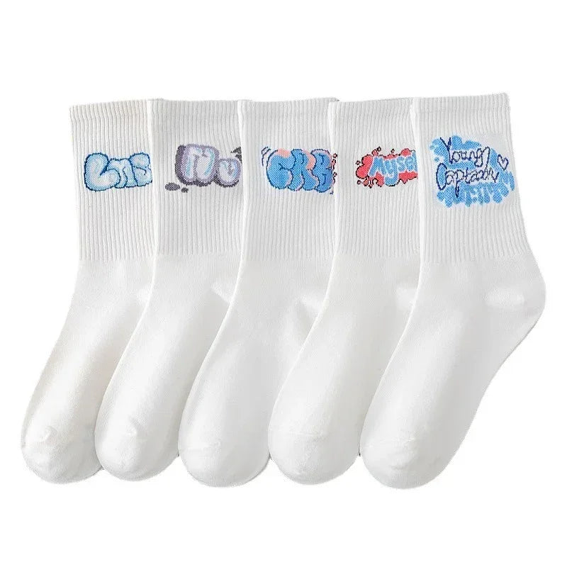 Set of five white crew socks with colorful graffiti-style text on ribbed cuffs