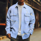 Man wearing light blue oversized shirt jacket with gold marble pattern, front pockets, and relaxed fit
