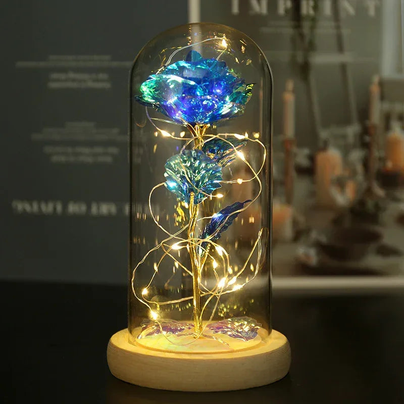 Holographic blue rose in glass dome with fairy lights, wooden base, modern decor.