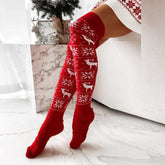 Red knitted over-the-knee socks with white reindeer and snowflake pattern, cozy fit